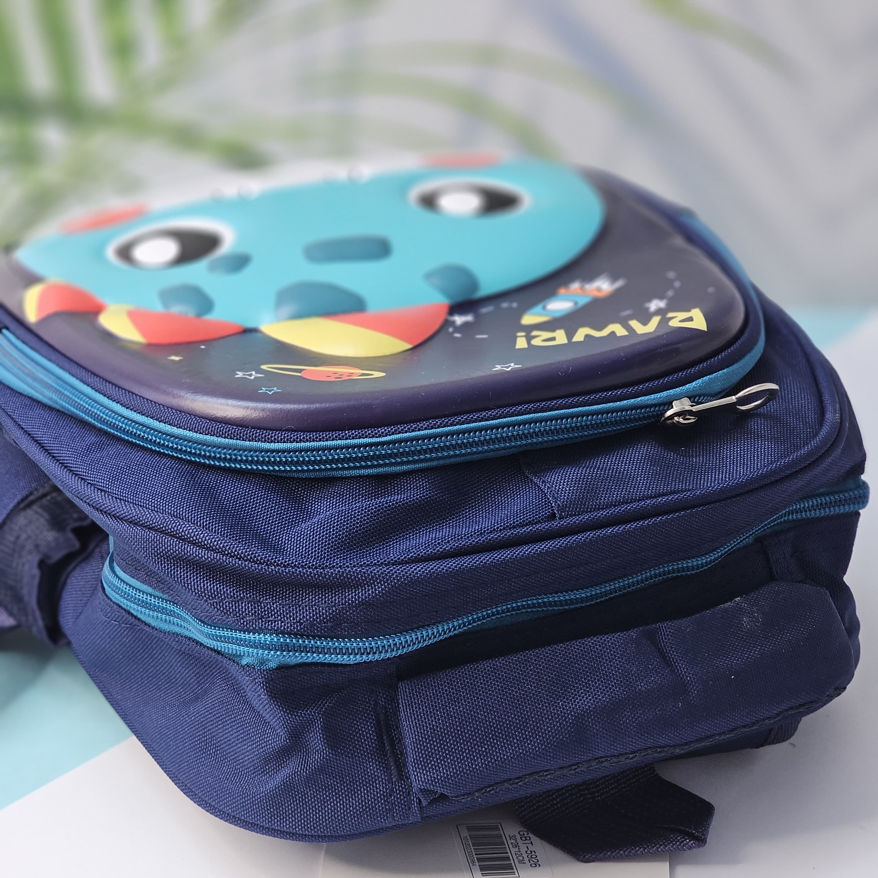 "Close-up of a Usmile Toys children's cartoon school backpack, designed in pink with a playful unicorn character on the front panel, and a matching pink water bottle in the side mesh pocket."